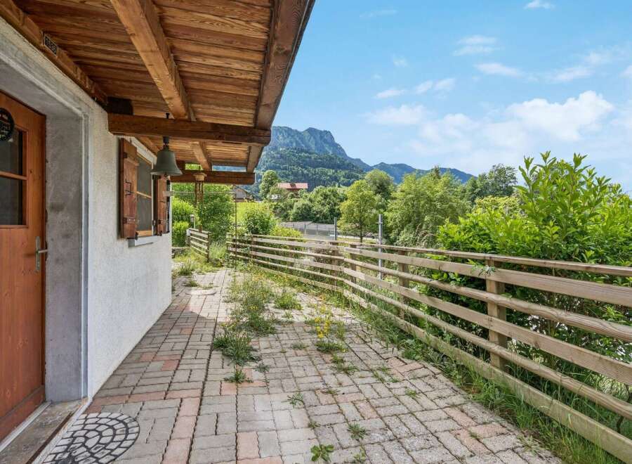 Enjoy the serene mountain views from the covered patio of this charming property.