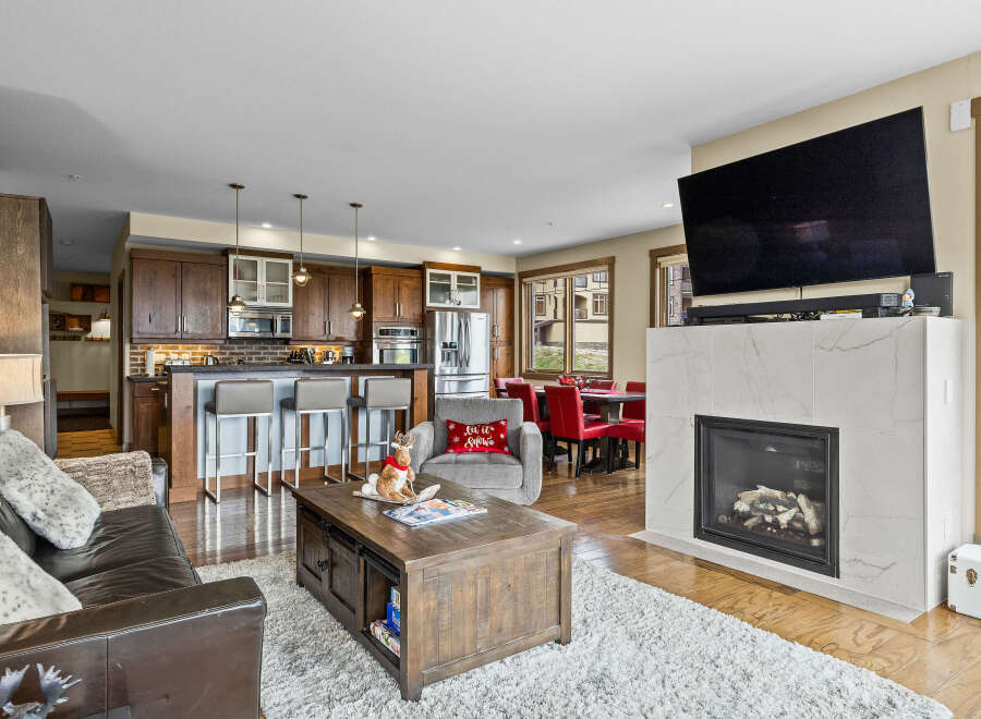 Experience modern living in this open-concept space featuring a gourmet kitchen with ample cabinetry and a breakfast bar, perfect for entertaining.