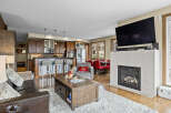 Experience modern living in this open-concept space featuring a gourmet kitchen with ample cabinetry and a breakfast bar, perfect for entertaining.