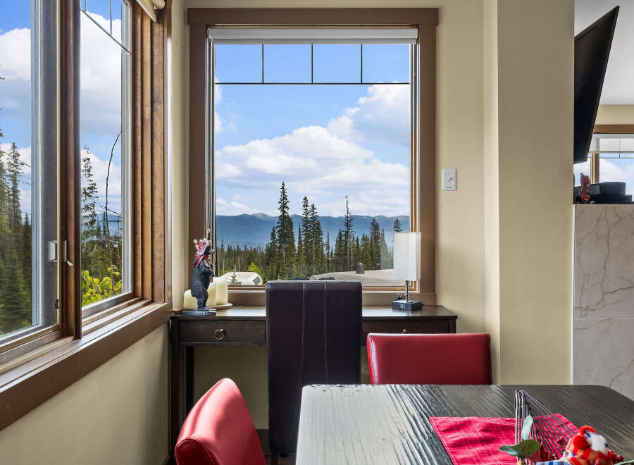 Enjoy breathtaking mountain and forest views from this dining area, perfect for morning coffee or evening meals.
