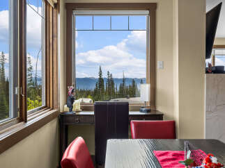Enjoy breathtaking mountain and forest views from this dining area, perfect for morning coffee or evening meals.