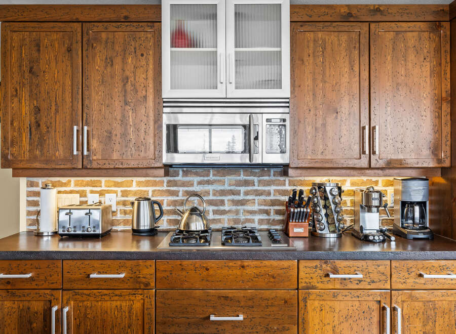 Experience rustic charm in this kitchen, featuring warm, distressed wood cabinetry that adds character and depth.
