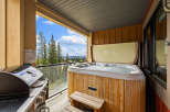 Enjoy the ultimate relaxation and entertainment on this private balcony, complete with a bubbling hot tub and a gas grill.