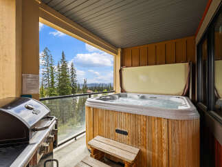 Enjoy the ultimate relaxation and entertainment on this private balcony, complete with a bubbling hot tub and a gas grill.