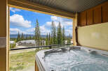Enjoy a relaxing soak in this private hot tub with stunning mountain views.
