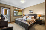 Experience ultimate comfort in this luxurious bedroom, featuring a plush king-size bed adorned with a cozy faux fur throw.