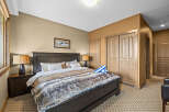 Experience ultimate comfort in this inviting bedroom, featuring a luxurious king-sized bed adorned with a plush faux fur throw.