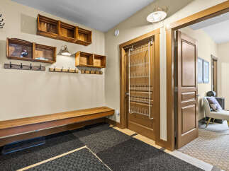 This entryway offers a practical and stylish space for organization and comfort.