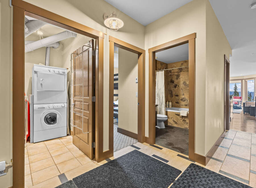 Discover convenience and comfort in this well-appointed property, featuring a dedicated laundry area with a stacked washer and dryer.