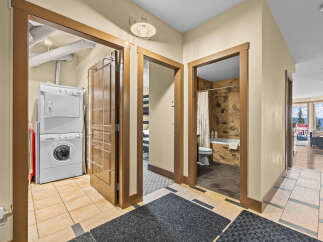 Discover convenience and comfort in this well-appointed property, featuring a dedicated laundry area with a stacked washer and dryer.