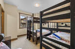 This charming bedroom features multiple bunk beds, perfect for accommodating family or guests.