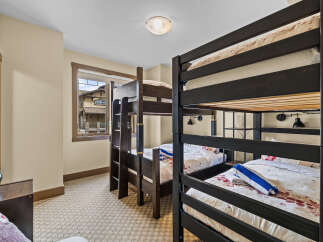 This charming bedroom features multiple bunk beds, perfect for accommodating family or guests.