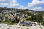 Discover this stunning mountain resort village offering a vibrant community with a mix of modern condos and chalets nestled amidst lush evergreen forests.