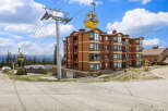 Experience mountain living in this stunning condo complex, featuring a vibrant exterior and convenient gondola access.