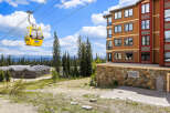 Experience the ultimate mountain lifestyle with this stunning property featuring a modern ski resort building and a scenic gondola ride.