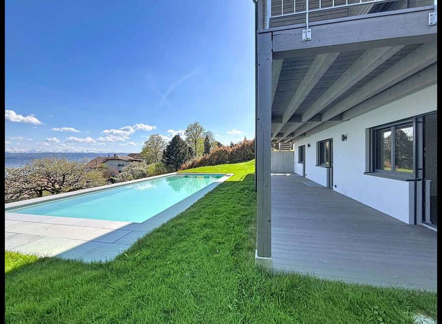 Experience modern luxury with this stunning property featuring a sleek infinity pool overlooking a picturesque landscape.