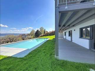 Experience modern luxury with this stunning property featuring a sleek infinity pool overlooking a picturesque landscape.