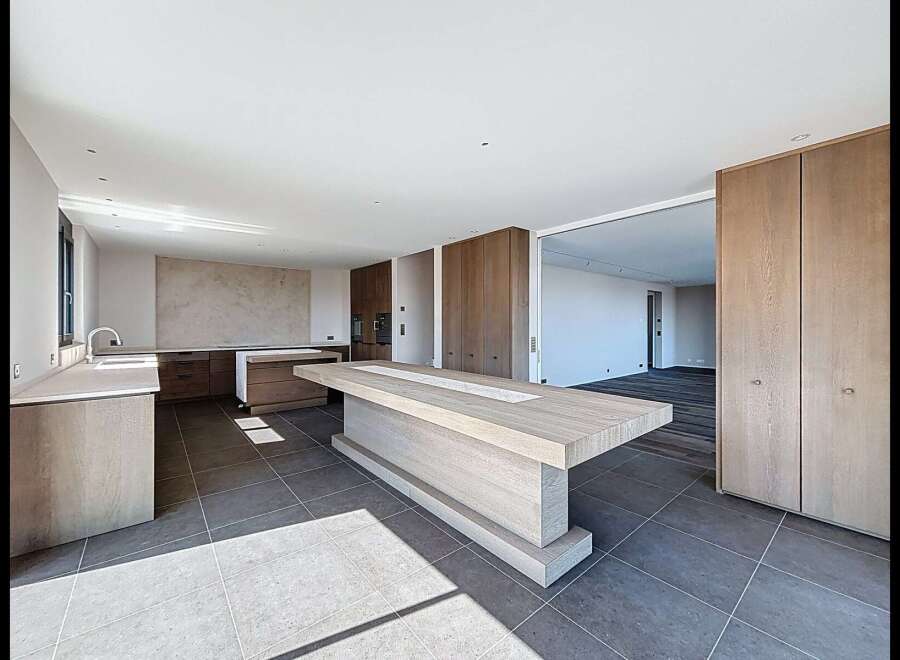 Experience modern luxury in this spacious open-plan kitchen and living area.