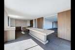 Experience modern luxury in this spacious open-plan kitchen and living area.
