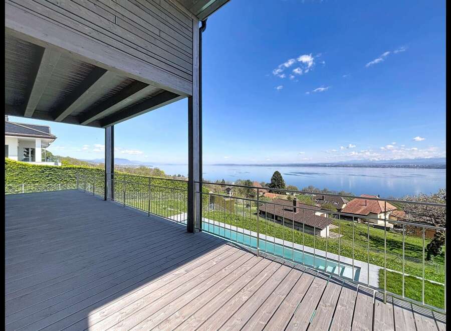 Experience breathtaking lake views from this stunning property, featuring a spacious deck perfect for entertaining or relaxing.