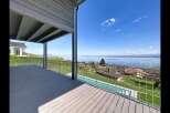 Experience breathtaking lake views from this stunning property, featuring a spacious deck perfect for entertaining or relaxing.