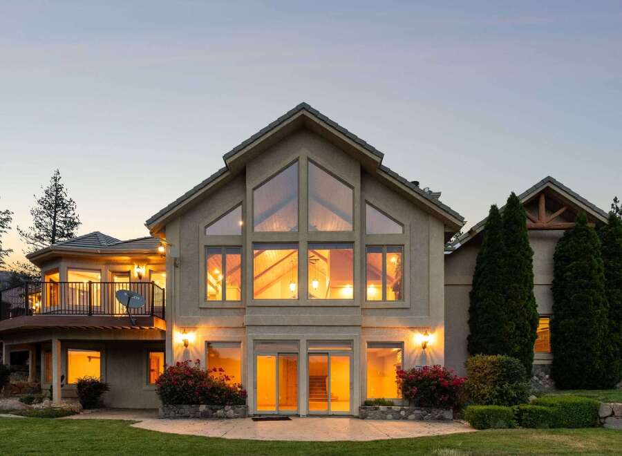 Experience luxury living in this stunning home featuring a grand, multi-story great room with expansive windows that flood the space with natural light.