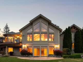 Experience luxury living in this stunning home featuring a grand, multi-story great room with expansive windows that flood the space with natural light.