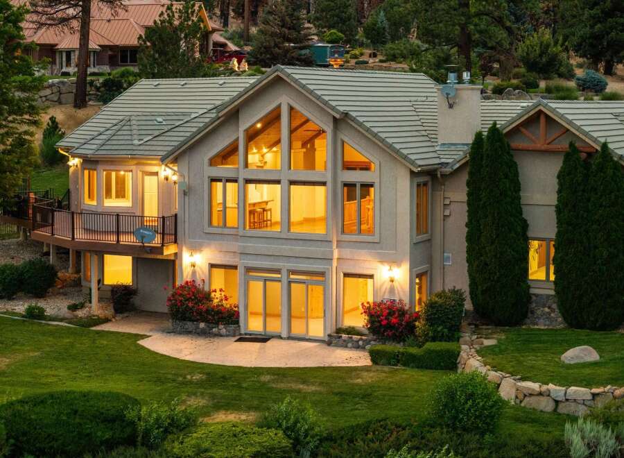 Experience luxury living in this stunning multi-level home, featuring expansive windows that flood the interior with natural light.
