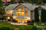 Experience luxury living in this stunning multi-level home, featuring expansive windows that flood the interior with natural light.