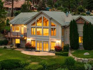 Experience luxury living in this stunning multi-level home, featuring expansive windows that flood the interior with natural light.