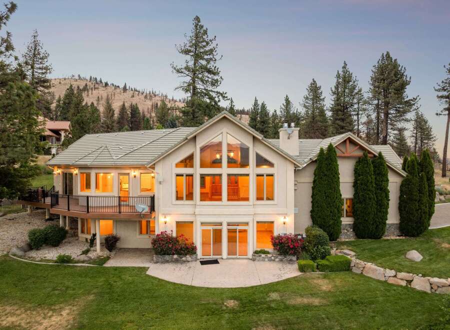 Experience luxury living in this stunning home, featuring a grand two-story great room with expansive windows that flood the space with natural light.