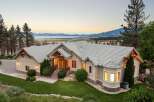 Experience luxury living in this stunning custom-built home, boasting panoramic views of the serene lake and majestic mountains.