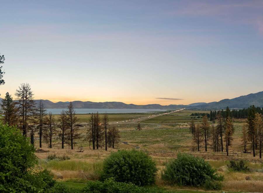 Experience breathtaking sunset views over the lake and mountains from this stunning property.