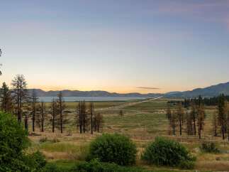 Experience breathtaking sunset views over the lake and mountains from this stunning property.