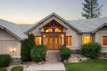 Experience luxury living in this stunning home featuring a grand entrance with double wooden doors and a covered porch.