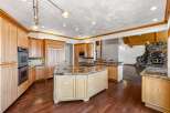 Experience luxury in this expansive kitchen featuring custom light wood cabinetry and granite countertops.