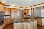 Experience luxury in this stunning kitchen, featuring custom light wood cabinetry and granite countertops.