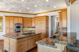 Experience luxury in this spacious kitchen featuring custom wood cabinetry and stunning granite countertops.