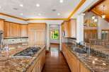 This spacious kitchen boasts custom wood cabinetry and granite countertops, perfect for any home chef.