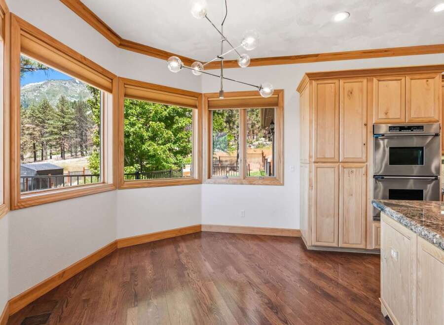 Experience breathtaking mountain views from this stunning dining area, featuring a unique bay window design that maximizes natural light and scenic vistas.