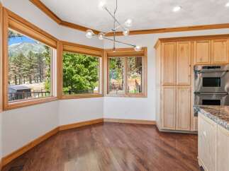 Experience breathtaking mountain views from this stunning dining area, featuring a unique bay window design that maximizes natural light and scenic vistas.