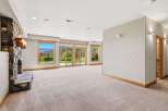 Experience breathtaking mountain views from this spacious living area, featuring a striking stone fireplace and expansive windows that flood the room with natural light.