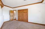 This bedroom features a warm and inviting atmosphere with its natural wood trim and doors.