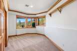 Experience breathtaking mountain views from this spacious room, featuring a charming bay window with rich wood trim.