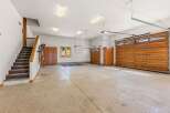 This spacious garage offers ample parking and storage with its large main bay and additional single-car garage.
