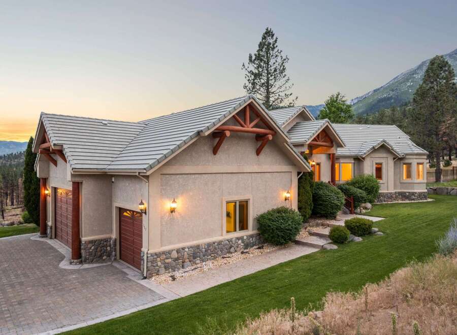 Nestled against a scenic mountain backdrop, this stunning home offers a perfect blend of rustic charm and modern elegance.