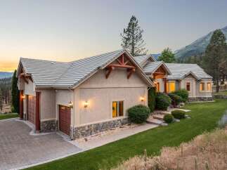 Nestled against a scenic mountain backdrop, this stunning home offers a perfect blend of rustic charm and modern elegance.