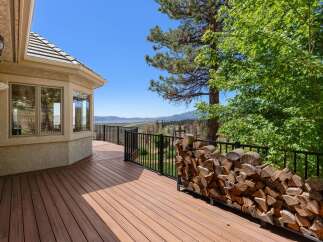 Enjoy breathtaking lake and mountain views from this expansive deck, perfect for entertaining or quiet relaxation.