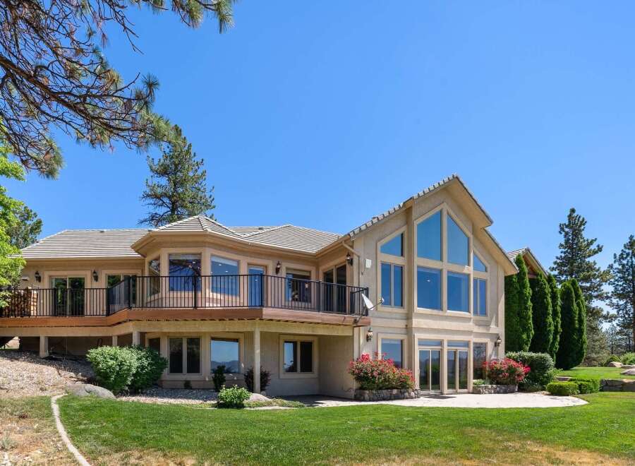 This stunning home boasts a multi-level deck perfect for entertaining, offering panoramic views of the surrounding landscape.