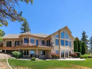 This stunning home boasts a multi-level deck perfect for entertaining, offering panoramic views of the surrounding landscape.